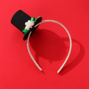 Detail of St. Patrick's Day mini top hat headband with green shamrock and gold glitter