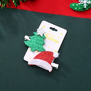 Detail of Christmas tree and Santa hat hair clips with glitter texture on display card