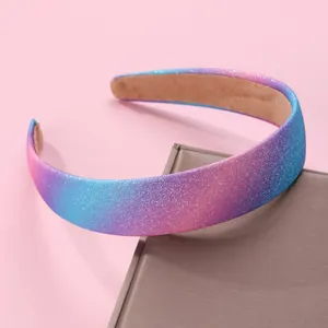 Detail of pink and blue gradient glitter headband on a decorative gift box