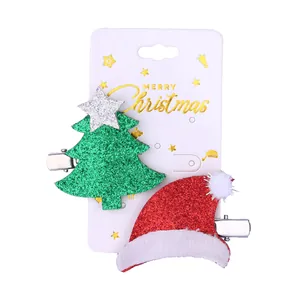 Christmas hair clips set featuring a glittery green tree and red Santa hat on white card