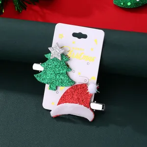 Christmas hair clips set featuring a sequined green tree and red Santa hat on a card