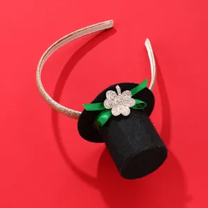 St. Patrick's Day headband with black mini top hat, green bow and golden shamrock details