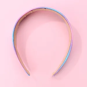 Close-up of glittery rainbow gradient headband with non-slip fabric lining detail