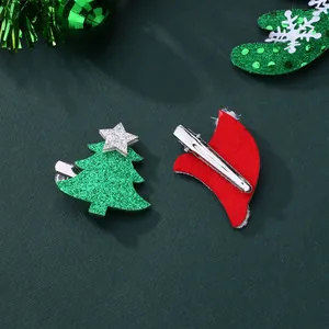 Close-up of glittery Christmas tree and red hat hair clips with metal alligator grips