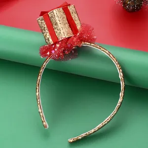Detail of Christmas headband featuring golden sequin bow and red glitter mesh lace