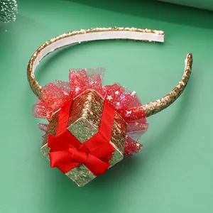 Christmas headband with gold sequin gift box and red mesh flower on green background