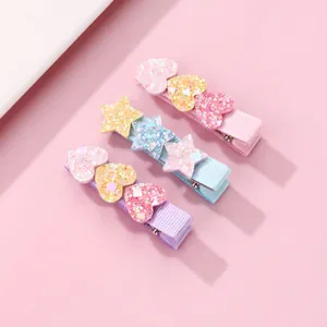Detailed view of glitter heart and star hair clips set for girls in pink, blue, and purple