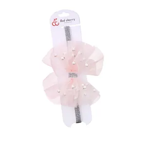 Pink tulle bow headband for kids featuring white pearls and silver glitter elastic band