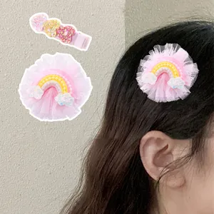 Detail of pink lace rainbow hair clip and sequin heart hair pins for little girls