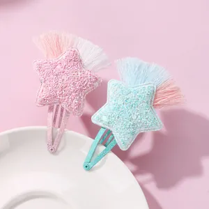 Detail of glittery star hair clips with tassels and non-slip metal BB clip for girls