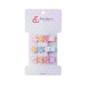 Three-piece set of glittery heart and star hair clips for girls on display card