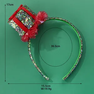 Detail of glittery green Christmas headband with mini gift box and red lace trim