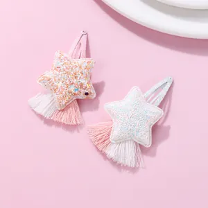 Detailed view of sequined star hair clips with soft fringe tassels and metal BB grips
