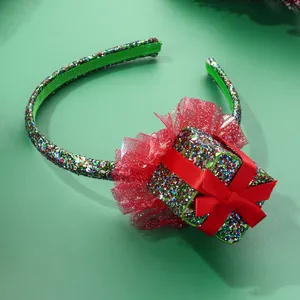 Close-up of festive Christmas headband with sequin gift box and red mesh detailing