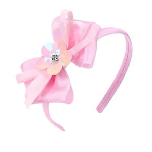 Sweet pink girls headband featuring a large satin bow and iridescent sequin flower