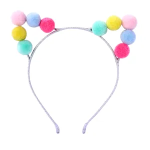 Cute kids cat ear headband with colorful pom-poms on a glittery silver frame