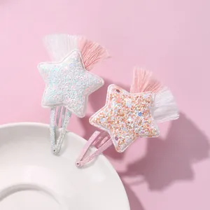 Close-up of star hair clips with glitter sequins and colorful thread tassels