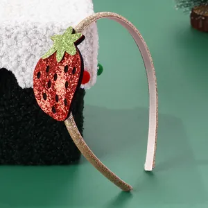 Close-up detail of sequined strawberry headband with golden glitter finish and non-slip lining