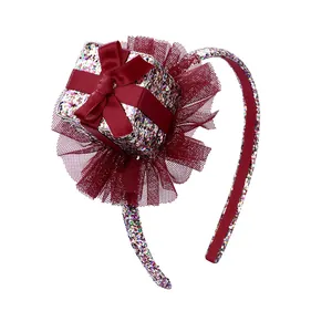 Glittery Christmas headband featuring a sparkling gift box and red tulle for party celebration