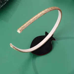 Detailed close-up of golden sequin headband with soft inner lining and festive pine decor
