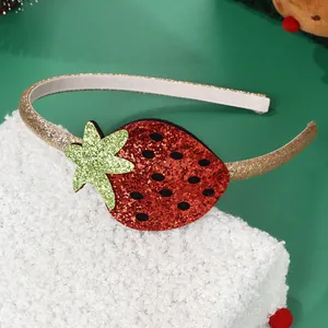 Sparkly strawberry headband with red sequins and green glitter leaves on a soft background