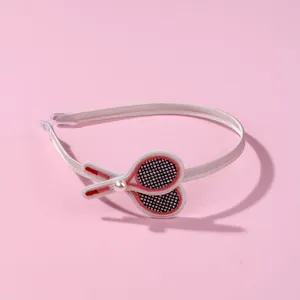 Kids sports headband with embroidered tennis rackets and pearl detail on beige silk