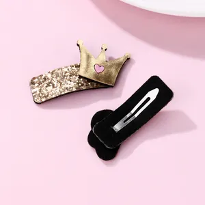Pair of glitter crown hair clips for kids with gold sequins and pink heart details