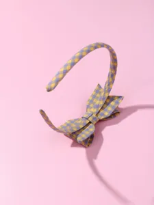 Detail of yellow and purple plaid fabric headband with a matching cute bow decoration