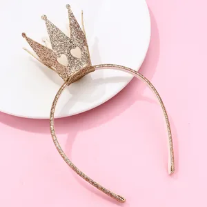 Detailed view of a gold glitter crown headband with heart cutouts for kids' parties