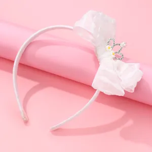 White organza bow headband with a rhinestone crown and daisy center for girls