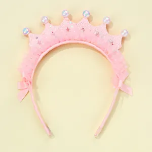 Detailed view of pink crown headband with delicate lace, shiny pearls and ribbon bows