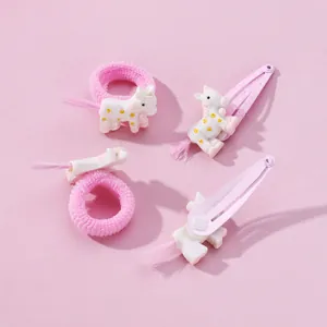Detailed view of pink unicorn hair clips and elastic hair ties for kids with synthetic hair tails