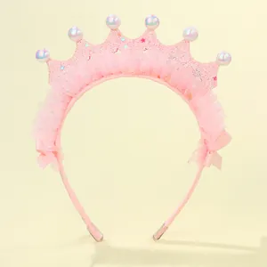 Close-up of pink glitter princess crown headband with lace mesh and pearlescent beads