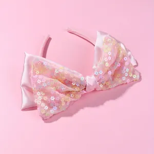 Pink fabric headband with a large satin bow and colorful floral sequins for girls