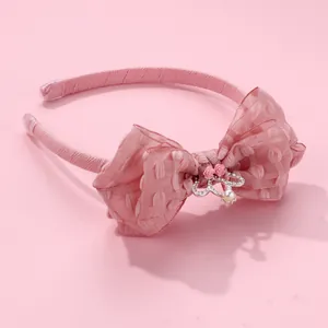 Close-up of pink organza bow headband featuring a mini silver crown and tiny fabric roses