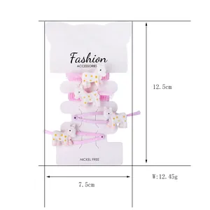 Detail of unicorn hair clips and ties set on display card with product dimensions