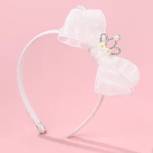 Detail of white organza bow headband with pearl crown and daisy accents for girls