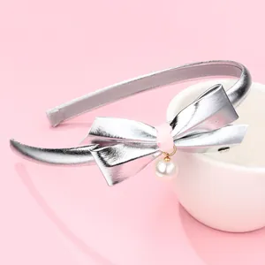Silver bow headband for girls featuring a pink ribbon center and elegant white pearl drop