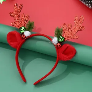 Close-up of glitter reindeer antlers headband with red bells and green pine needles