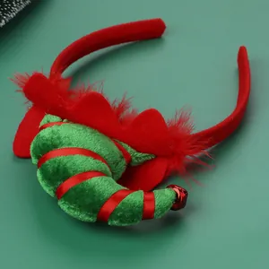 Christmas elf hat headband with red feathers and a small jingling bell on green background
