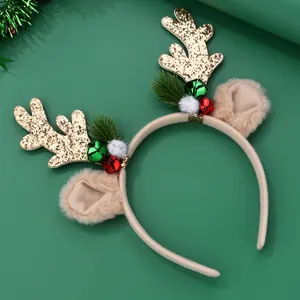 Detail of Christmas reindeer antler headband with gold glitter, bells, and pine needles