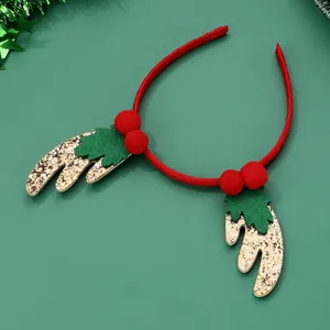 Festive Christmas headband with red pom-poms, green leaves and gold glitter reindeer antlers