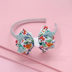 Cerchietto glitterato per bambini con fiocco a fiori e dinosauri su sfondo rosa