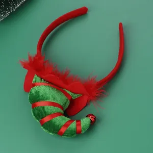 Detailed view of Christmas headband with green elf hook, red ribbon and bell