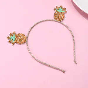 Sweet children headband with pineapple embroidery and glitter detail on pink background