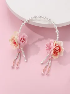 Detail of handmade floral headband with pink roses, pearls, and tassel drops for hair