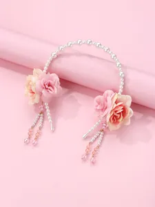 Close-up of pearl flower headband with pink rose details and elegant tassels