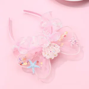 Detailed view of pink lace headband featuring sequined starfish and seashell mermaid accents