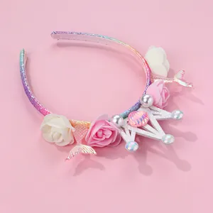 Detail of mermaid crown headband featuring colorful fish tails and rose flowers
