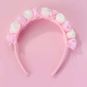 Close-up of pink and cream rose petals with lace frill on a glittery floral headband